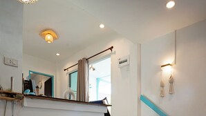 A room with a bed, a staircase, a mirror, and a light fixture. - Dream Villa Beachfront Sunset (Koh Samui)