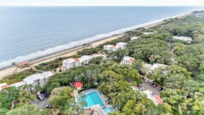 A coastal property with a swimming pool, beach access, and dense greenery. - Salt Air Nook - Pool Access (Jekyll Island)