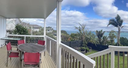 Newly finished self-contained unit above Arkles Bay watch sunset over Auckland