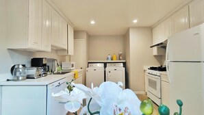 A compact kitchen with white appliances, a coffee maker, a microwave, and a sink. - 261-6 Cozy 2-Bedroom Apartment near Downtown Mountain View (Mountain View)