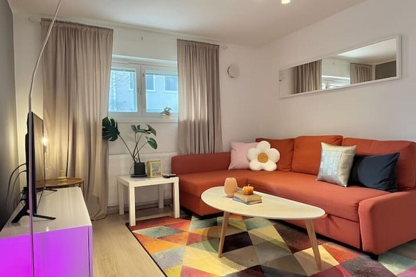 Set the mood with the Philips Hue Iris ambiance Smart Lamp, casting a soft, relaxing glow in the living room.