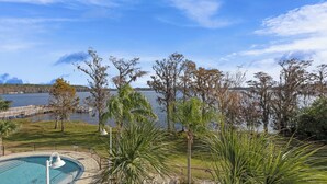 Una piscina con vistas a un lago y árboles.