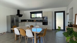 A modern kitchen with a dining area.