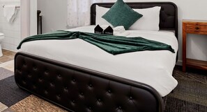 A neatly made bed with a dark headboard, white bedding, and a green throw blanket. - Peaceful 1BR Stay - Golf & Beach (Pacifica)