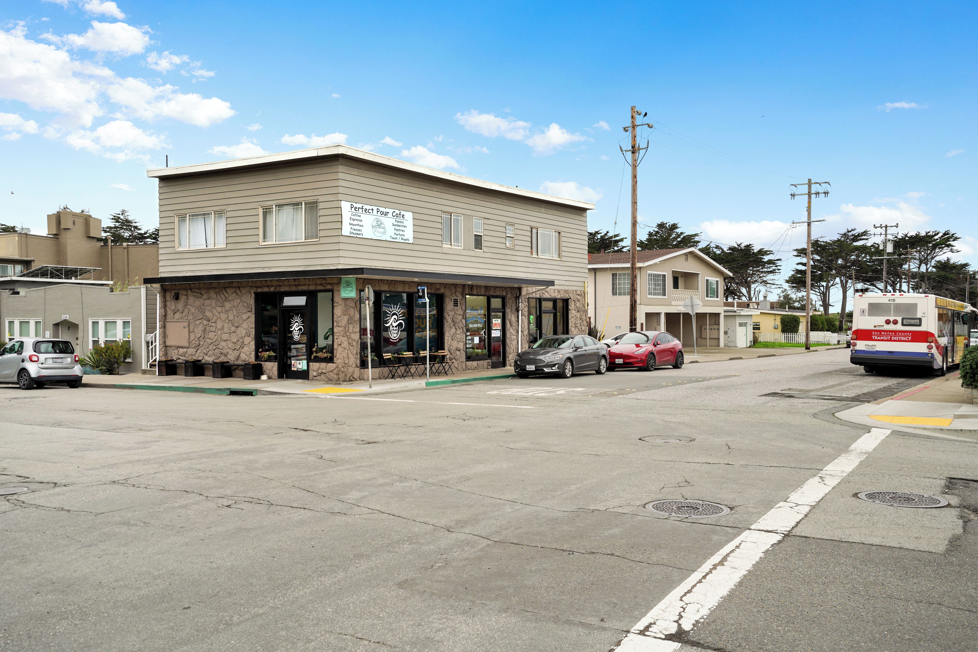 A two-story building with a cafe named "Perfect Pour Cafe" on the ground floor.