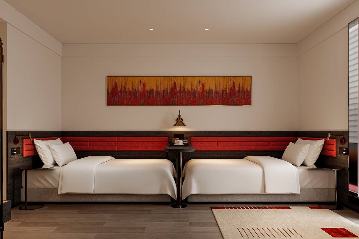 Ein modernes Schlafzimmer mit zwei Betten, einem roten Kopfteil und einem großen, abstrakten Gemälde an der Wand.