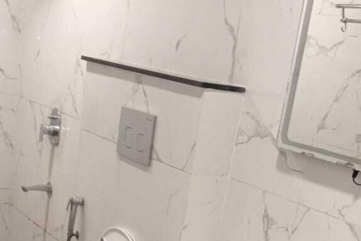 A bathroom with a white sink, a toilet, and a bidet.