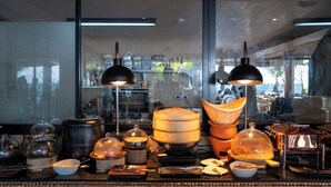 A kitchen counter with various cooking utensils and cookware, including pots, pans, and a wooden steamer. - Irene Resort Koh Lipe (Koh Lipe)