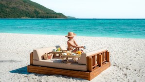 A beachside setting with a wooden deck and a cushioned seating area. - Irene Resort Koh Lipe (Koh Lipe)
