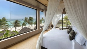 A bedroom with a large window, a bed, and a view of the beach. - Irene Resort Koh Lipe (Koh Lipe)