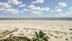 A beach with a wooden boardwalk and palm trees. - 518 Seascape | Waterfront Views + Community Pool (Isle Of Palms)