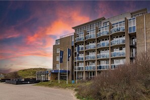 Hotel building with balconies on each floor, offering stunning views.