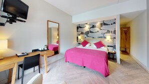 Relax in a stylish room with a comfortable bed, desk, and flat-screen TV.