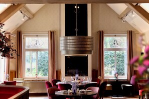Enjoy a warm and inviting dining experience with comfortable seating and elegant table settings.