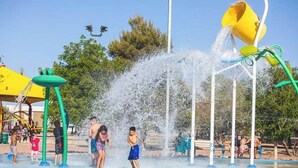 A water park with various water features and play structures.