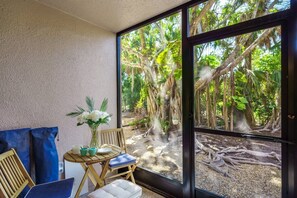 Gather, relax, and enjoy the fresh air on this comfortable patio. - Secluded End Unit | Private Beach | Dog Friendly (Siesta Key)