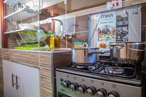 Exclusive Apartment, Pool View | Private kitchen | Fridge, microwave, cookware/dishes/utensils - Prime Nomads (Kisumu)