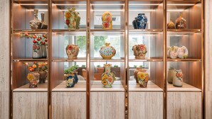 A display of various vases and decorative items on shelves. - San Seize Hanoi Hotel (Hanoi)