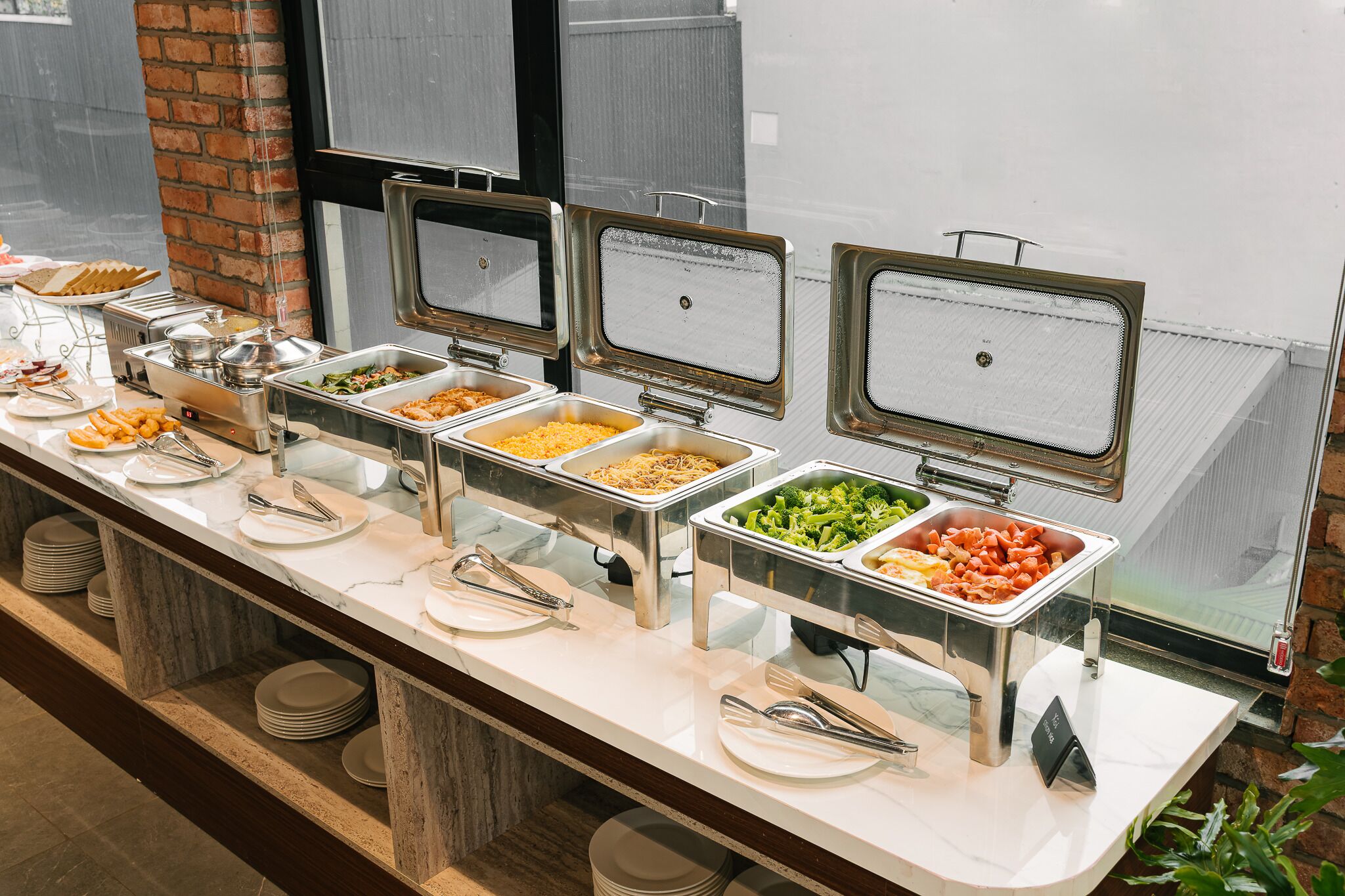 A buffet with multiple food stations, including pasta, salads, and other dishes.