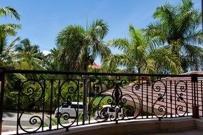 Enjoy a scenic view of the street and lush palm trees from this balcony.