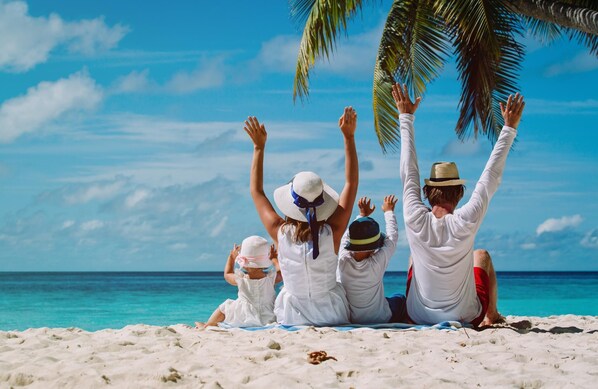 Family enjoys a leisurely day at the beach with ocean views.