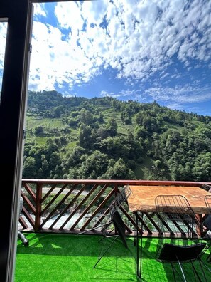 Enjoy breathtaking views of the lush valley from this balcony.