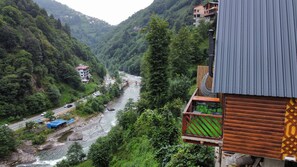 Surrounded by mountains, this serene valley offers breathtaking views of a flowing river and charming buildings.