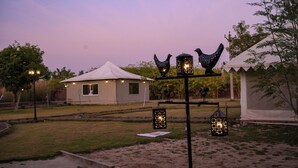 A tented outdoor area with decorative lanterns and a small building with a white roof. - Impian Resort (Jodhpur)
