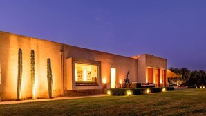 A modern building with large windows and a sculpture in the foreground. - My Rental Homes - Villa Noria with garden and private pool (Marrakesh)