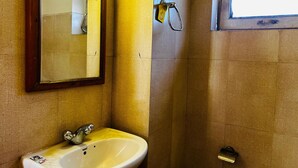 A bathroom with a sink, mirror, and window. - Hostelam The Mountain Story (Manali)
