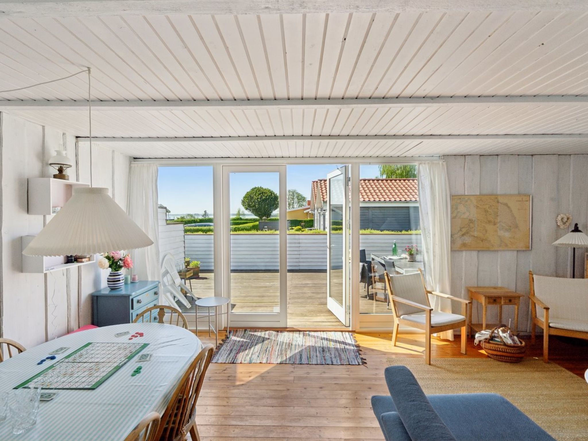 A spacious room with a large sliding glass door leading to an outdoor patio area.