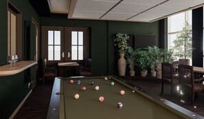 Una mesa de billar con bolas, una zona de bar y asientos.