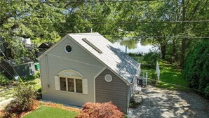 A single-story house with a gabled roof, a small front porch, and a well-maintained lawn.