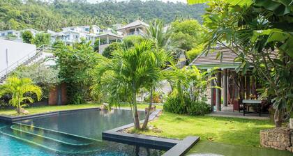 Serene 2-bedroom retreat with balcony, pool, and stunning views