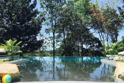 Tropical retreat with air-conditioned bedroom, pool, and bar