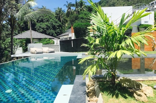 Tropical retreat with air-conditioned bedroom, pool, and bar