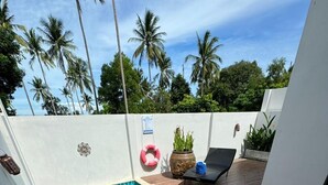 A rectangular swimming pool with blue tiles, surrounded by a wooden deck. There is a lounge chair and a potted plant on the deck. - Stylish 2-Bedroom VIlla in Plai Laem, Private Pool with Jacuzzi, Close to Attractions (Koh Samui)