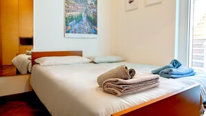 Ein Hotelzimmer mit Bett, einem Bild an der Wand und einem Fenster.