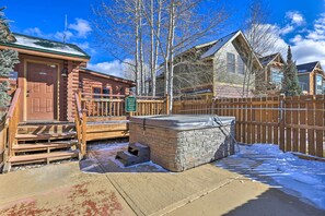 A log cabin with a wooden deck and a hot tub. - Modern Granby Retreat: Fish, Hike & Relax! (Granby)