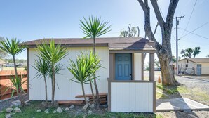 A small, single-story building with a blue door and a small porch area. - Studio 2 Mi to Feather River: Bring Your Pet! (Oroville)