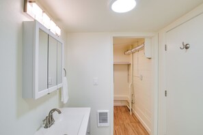 A bathroom with a sink, mirror, and shower area. - 2 Mi to Feather River: Outdoor Escape in Oroville! (Oroville)