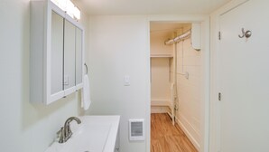 A bathroom with a sink, mirror, and shower area. - 2 Mi to Feather River: Outdoor Escape in Oroville! (Oroville)