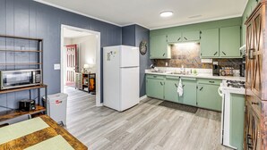 A compact kitchen with a microwave, refrigerator, and green cabinets. - < 5 Mi to Dtwn Walterboro: Grill, Game & More! (Walterboro)