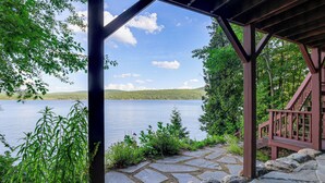 A stone pathway leading to a wooden deck overlooking a lake with a clear sky. - 'sweet Serenity' Schroon Lake Family Retreat! (Schroon Lake)