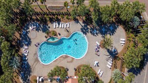 An aerial view of a swimming pool surrounded by palm trees and lounge chairs. - Destiny's Paradise | Lux Home, Golf Cart, Private Pool (Destin)