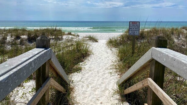 A beach path leading to the ocean with a notice sign. - Destiny's Paradise | Lux Home, Golf Cart, Private Pool (Destin)
