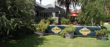 A landscaped area with a sign for 'Bulmers Original Cider'.