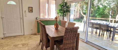 Enjoy meals in this dining area with a large sliding glass door leading to an outdoor patio.