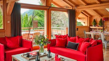 Luxury Chalet, 5 Bedrooms, Mountain View | Living area | 50-inch Smart TV with digital channels, fireplace, table football