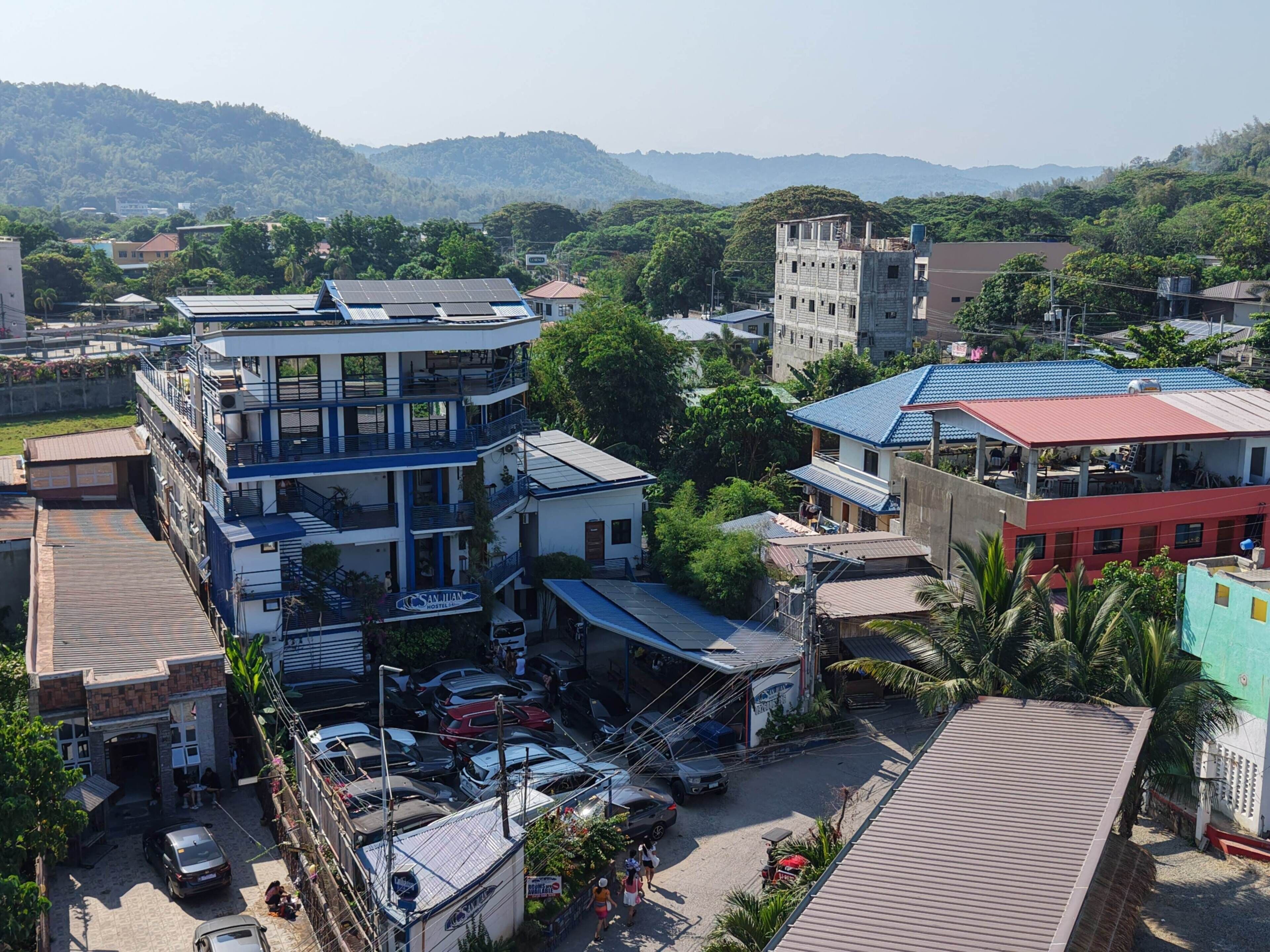 A multi-story building with a hostel named "Sanitan Hostel" on the ground floor.